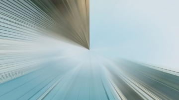Abstract image featuring two vanishing points meeting at the center, with lines radiating outward; left side is brownish, right side is blue, creating a dynamic, futuristic visual effect.